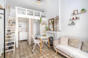 a living room with a couch and a table at Logement cosy centre Beaucaire - C2 in Beaucaire