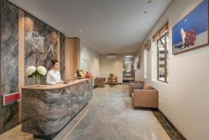 a woman sitting at a counter in a lobby at Lam Anh Hotel 10 Ngoai Giao Doan in Hanoi