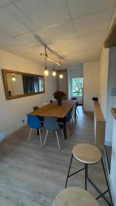 a dining room with a wooden table and chairs at Gite Les Pivoines in Saint-Robert