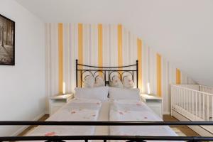 a bedroom with a bed with a wrought iron headboard at Reiselust in Stockach