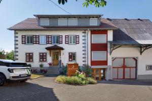 a house with a car parked in front of it at Reiselust in Stockach