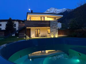 a house with a swimming pool in front of it at La villa del lago in terrazzo in Colico