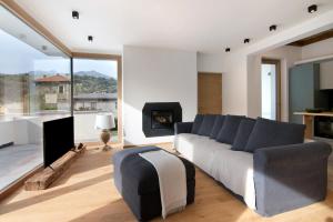 a living room with a couch and a fireplace at La villa del lago in terrazzo in Colico