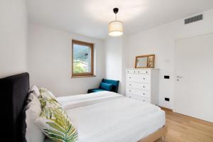 a bedroom with a white bed and a blue chair at La villa del lago in terrazzo in Colico +32 photos