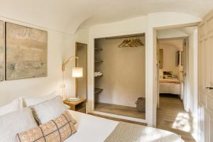 a bedroom with a white bed and a room with a bed sqor at El Celler - Can Bonet in Sant Martí Vell +29 photos