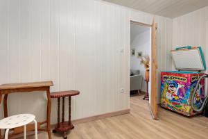 a living room with a table and a refrigerator at Les Écrins de Campan in Campan