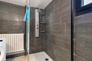 a bathroom with a shower and a toilet at Les Écrins de Campan in Campan +20 photos