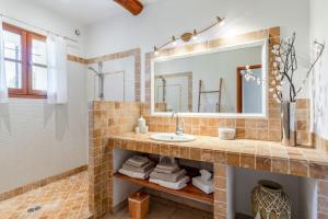 a bathroom with a sink and a mirror at La Grange Bessac in Violès