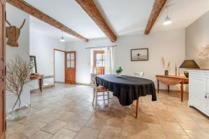 a large living room with a table and chairs at La Grange Bessac in Violès +30 photos