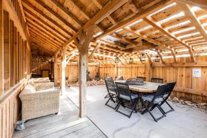 a wooden pavilion with a table and chairs at Villa Chan-Ly in Lacanau