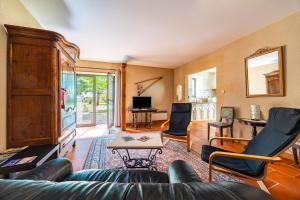 a living room with a couch and chairs at La Maison de Piquereau in Sauveterre-de-Guyenne