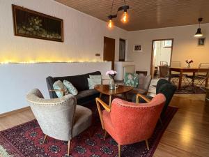 a living room with a couch and chairs and a table at Auf dem Karlsberg in Weilburg