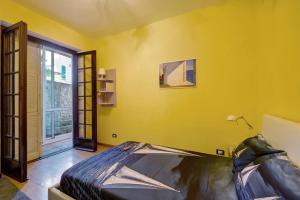 a yellow room with a bed and a window at Casa Sole e Mare in Arenzano +20 photos