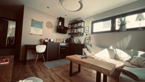 a living room with a couch and a table at Zone 3 in Erfurt