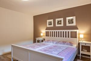 a bedroom with a large bed with two night stands at Ferienwohnung Gabler in Möhnesee