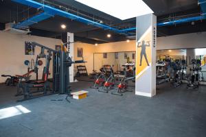 a gym with several treadmills and exercise bikes at U by Z Hotels, Bellandur in Bangalore