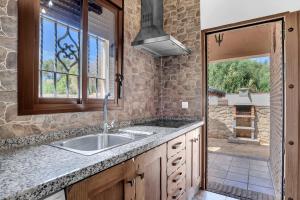 a kitchen with a sink and a window at Casas al Alba 2 in Zahora +14 photos