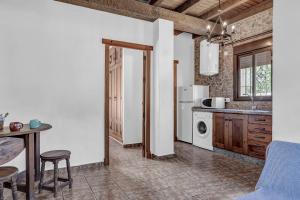 a kitchen with a table and a stove top oven at Casas al Alba 2 in Zahora