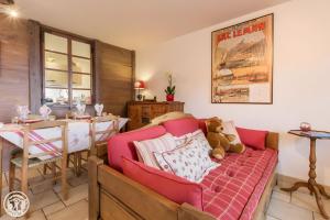a living room with a couch with a teddy bear at Gîte Chez Mayon in Orcier