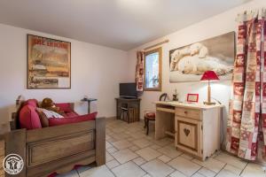 a living room with a couch and a desk at Gîte Chez Mayon in Orcier +16 photos