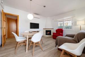 a living room with a table and chairs and a couch at Ca La Lola in Llorenç del Penedes