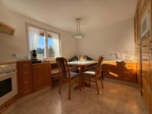 a kitchen with a table and chairs and a window at Central Home in Krumbach in Krumbach +22 photos