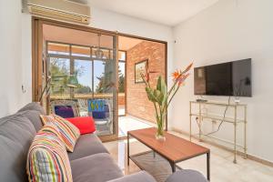 a living room with a gray couch and a table at Apartamento Ombú in La Herradura