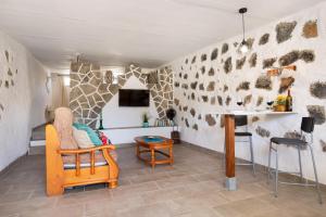 a living room with a chair and a table at Esencia Eco-rústico Adults Only in El Charco