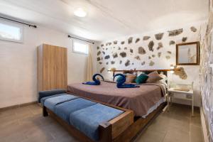 a bedroom with a bed with blue towels on it at Esencia Eco-rústico Adults Only in El Charco +18 photos