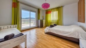 a bedroom with two beds and a large window at Costacabana - Villa Primavera in Lloret de Mar +12 photos