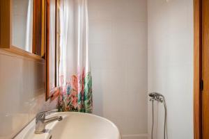 a bathroom with a sink and a shower curtain at Mirador de la Abuela in Gáldar +16 photos