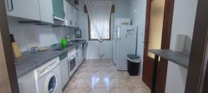 a kitchen with a sink and a refrigerator at Casa rural El rincón de Gredos in Navaluenga +37 photos