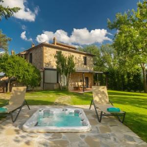 a patio with chairs and a hot tub in front of a house at Villa Assolata in Pietraviva