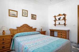 a bedroom with a bed with a blue comforter at Villa Carmen in Hozanejos +17 photos