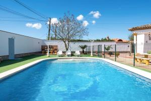 a swimming pool with blue water in a yard at Villa Carmen in Hozanejos