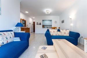 a living room with two blue couches and a table at 234 Parque playa La cala in La Cala de Mijas