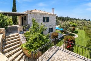 an image of a villa with a garden and stairs at Goudis Villa Thanasis in Lefkada