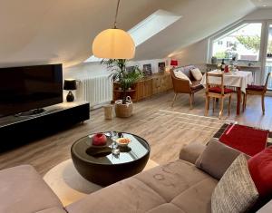 a living room with a couch and a table at Ferienwohnung Klosterblick in Öhningen