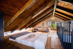 a large bedroom with two beds in a attic at El Paraíso Del Olivar in Bollullos de la Mitación +24 photos