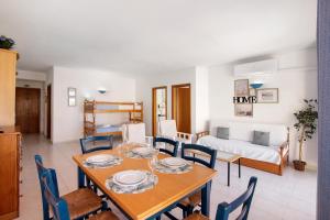 a dining room and living room with a table and chairs at Casa Néctar in Armação de Pêra