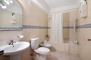 a bathroom with a toilet and a sink and a tub at Casa Néctar in Armação de Pêra +16 photos