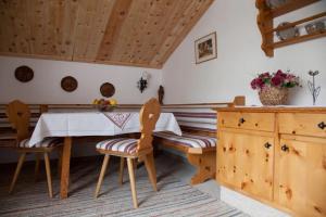 a kitchen with a table and chairs in a room at Landhaus Reiser in Grainau