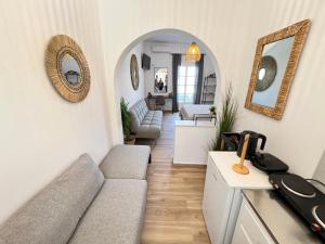 a living room with a couch and a table at aeolian blu 7 in Parikia +36 photos