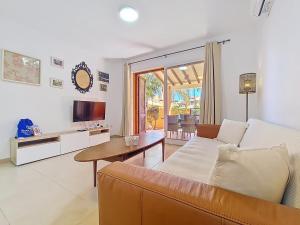 a living room with a couch and a table at Albatros Playa 3 - 1207 in Mar de Cristal
