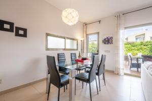 a dining room with a glass table and black chairs at Astur - Moderno Chalet Con Piscina in Puigderrós