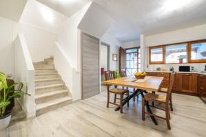 a kitchen and dining room with a table and stairs at Casa vacanze Elifra in San Giovanni Suergiu