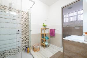 a bathroom with a shower and a sink at Casa vacanze Elifra in San Giovanni Suergiu +17 photos