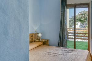 a bedroom with a bed and a window at Casa entera Empuriabrava y terraza in Empuriabrava