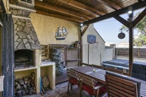 a patio with a wooden table and a fireplace at Casa entera Empuriabrava y terraza in Empuriabrava