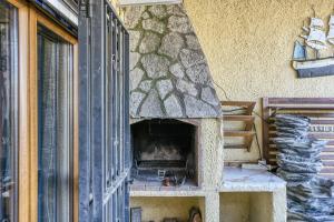 a stone pizza oven on the side of a building at Casa entera Empuriabrava y terraza in Empuriabrava